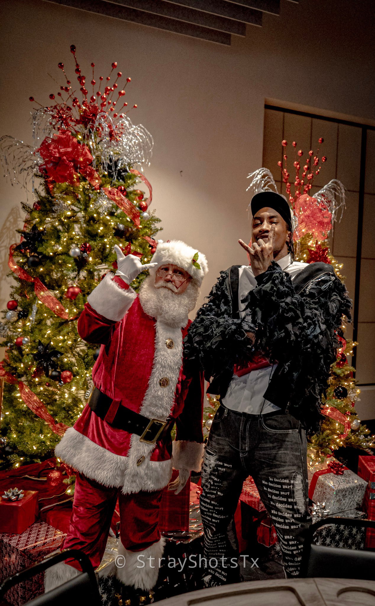 Santa sharing a playful moment with a guest at a Christmas event