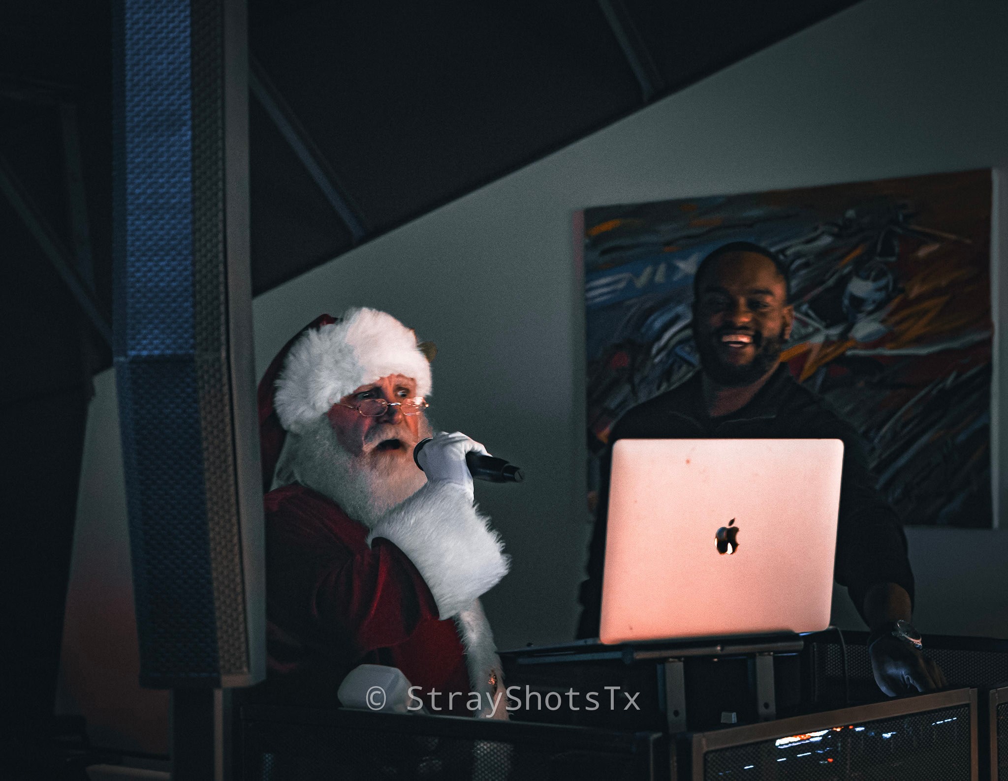 Santa speaking into a microphone at a community event